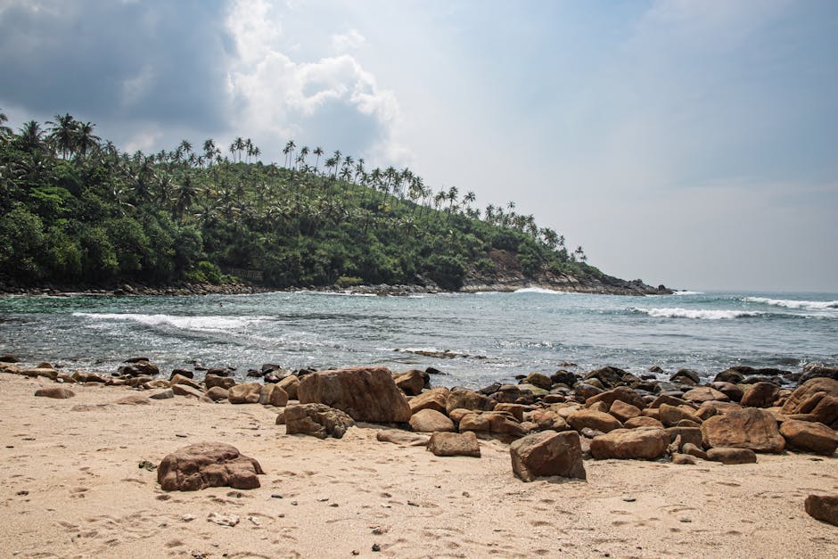 Explore the tranquil Secret Beach in Mirissa, Sri Lanka, with lush greenery and rocky shorelines.