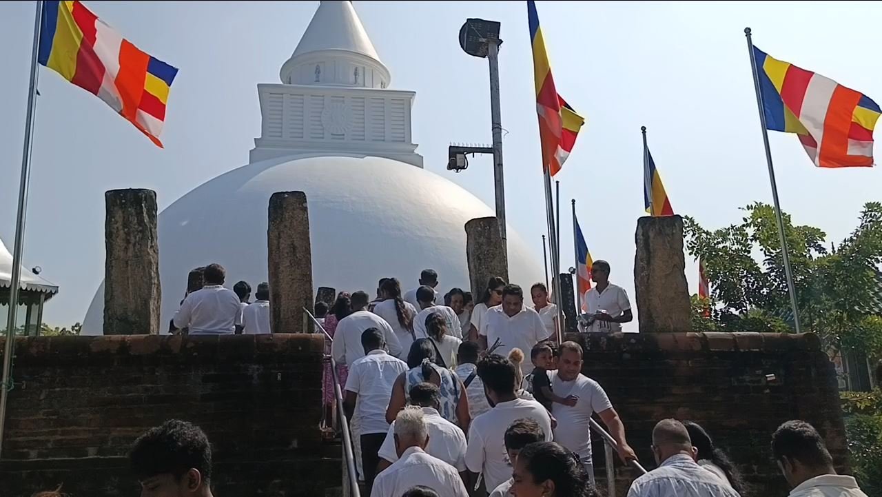 Pilgrims in white climbing towards the Kiri Vehera stupa at Kataragama