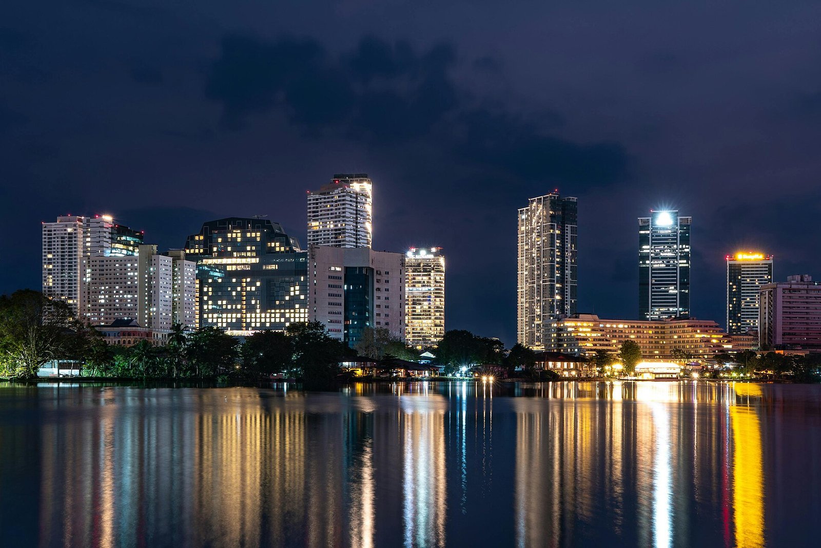 Colombo skyline lit up at night and reflected in the water