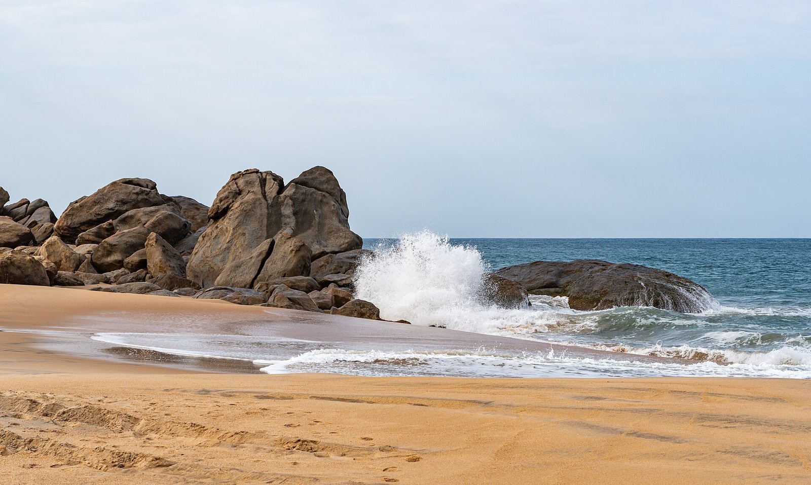 Waves breaking on boulders at Panama beach near Arugam Bay