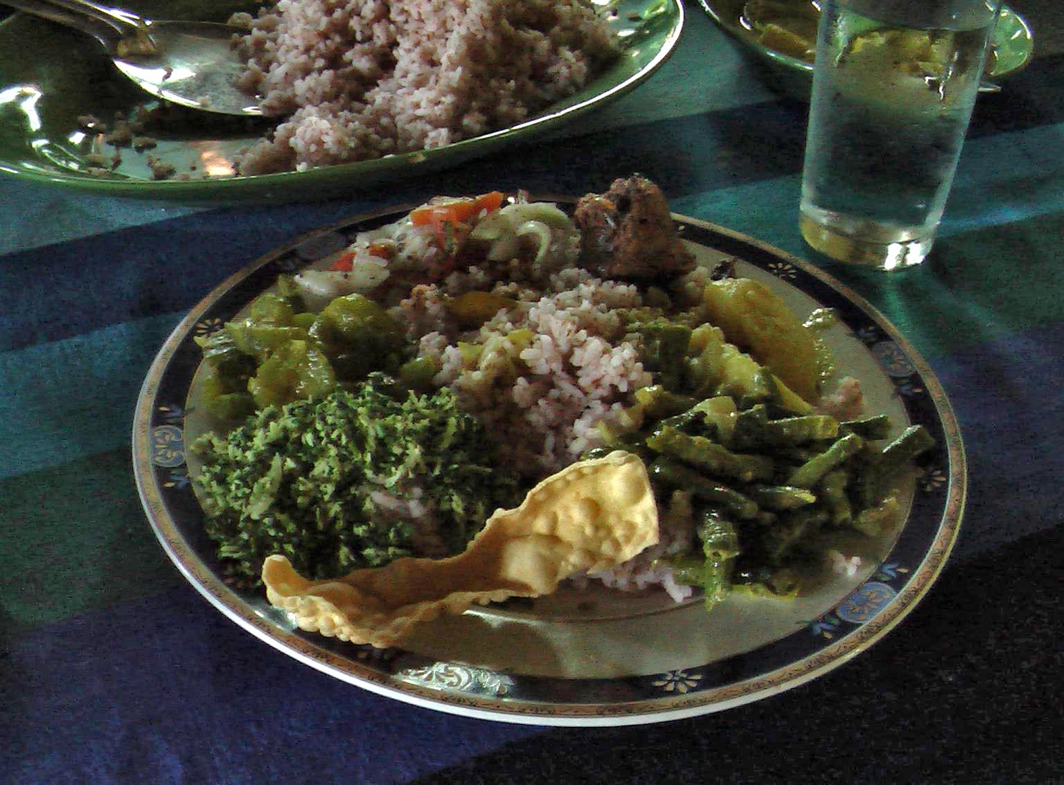 Plate of Sri Lankan rice and curry with vegetable dishes and papadam