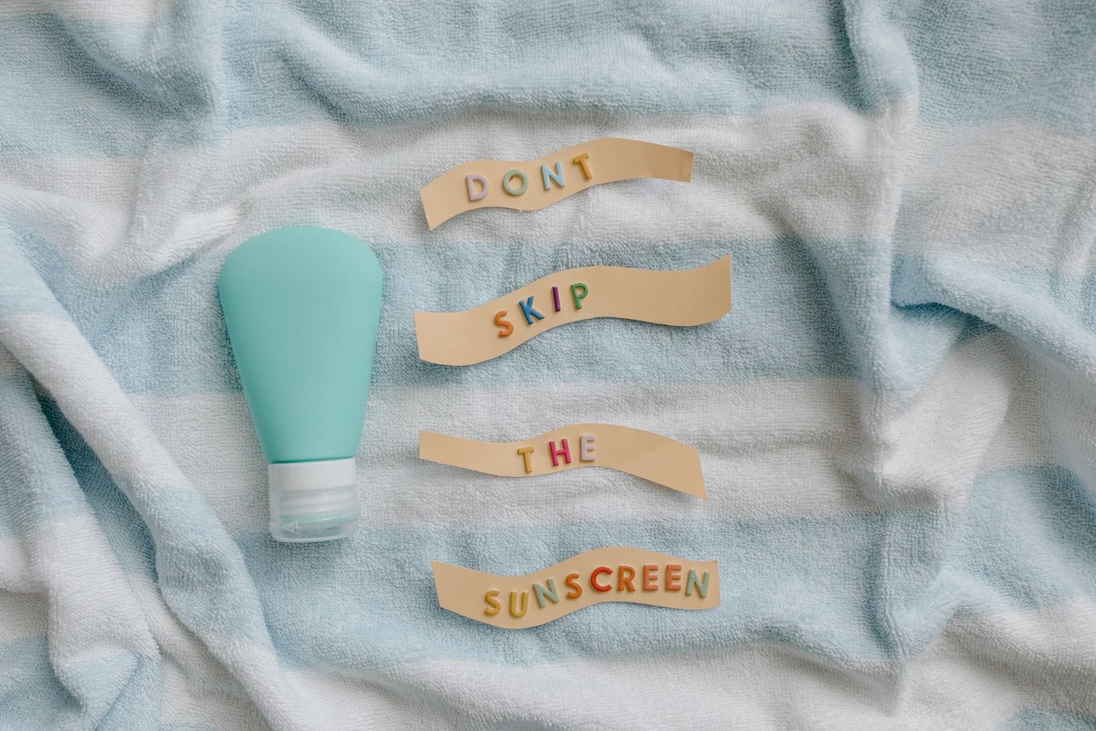 Sunscreen bottle on a beach towel