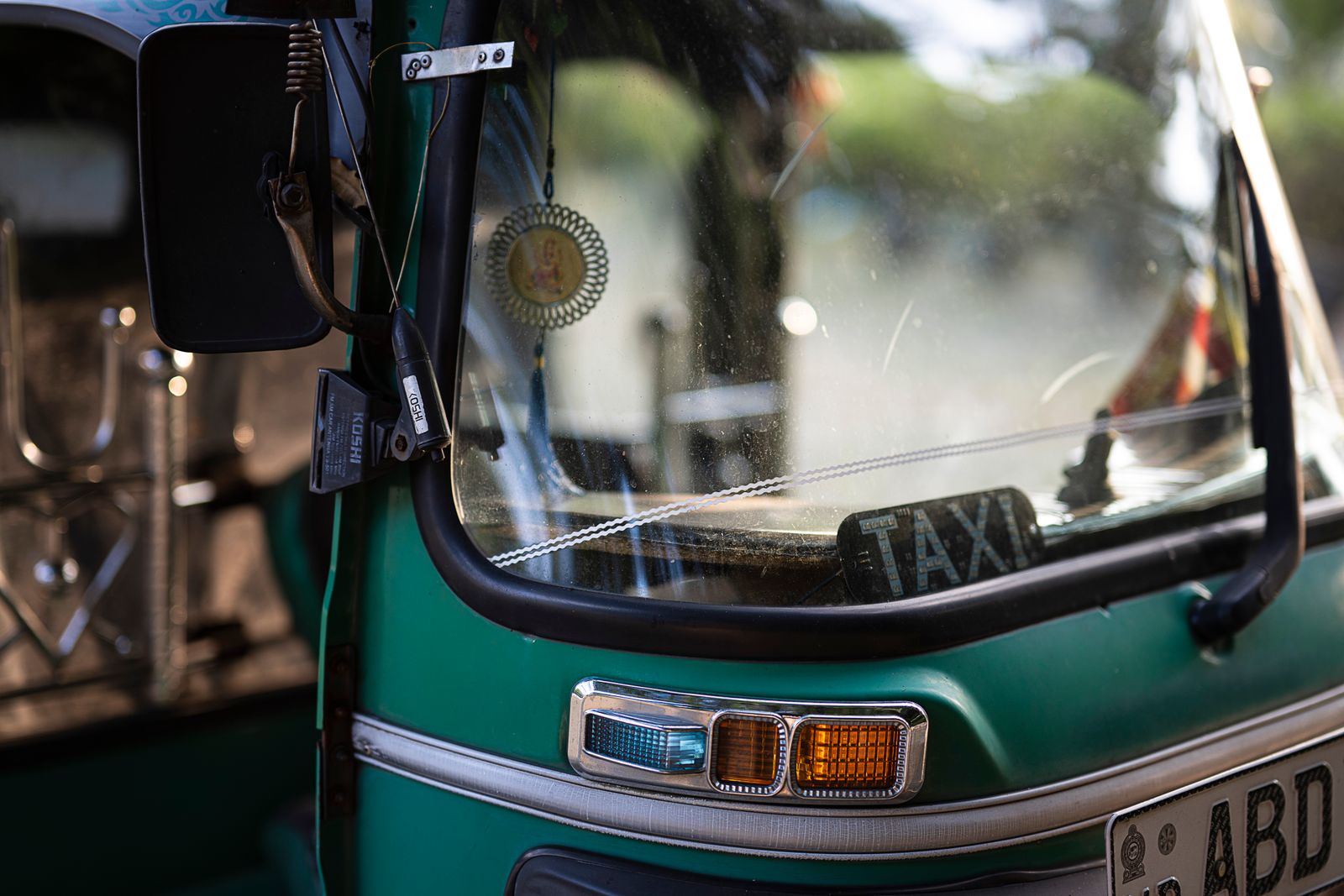 A green tuk-tuk taxi in Colombo, Sri Lanka