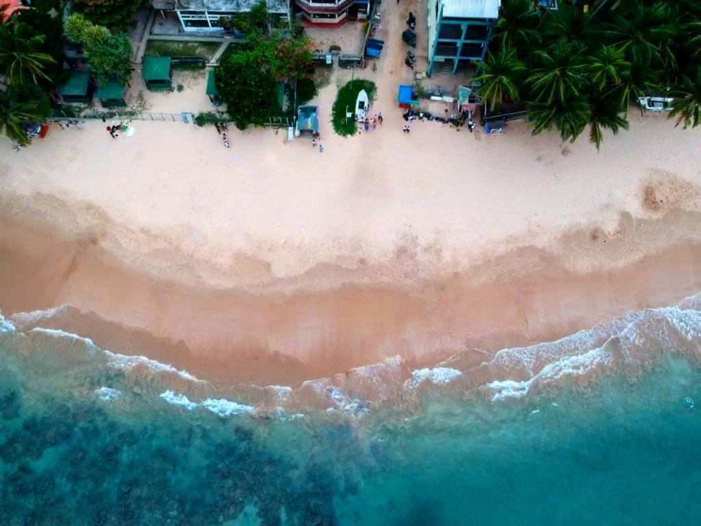Popular beach with a coral reef for snorkeling, plus glass bottom boat tours & surfing